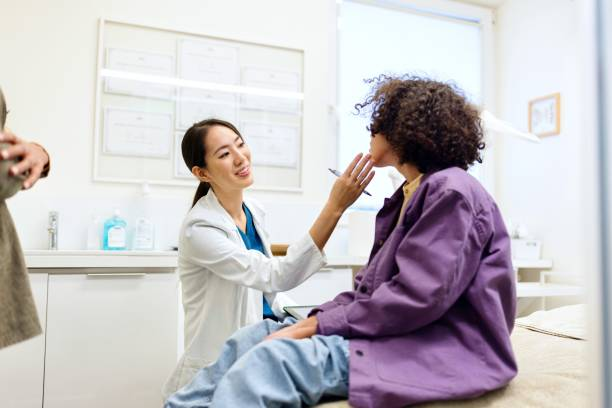 A doctor checks out a patient, discussing skin hydration and overall wellness.
