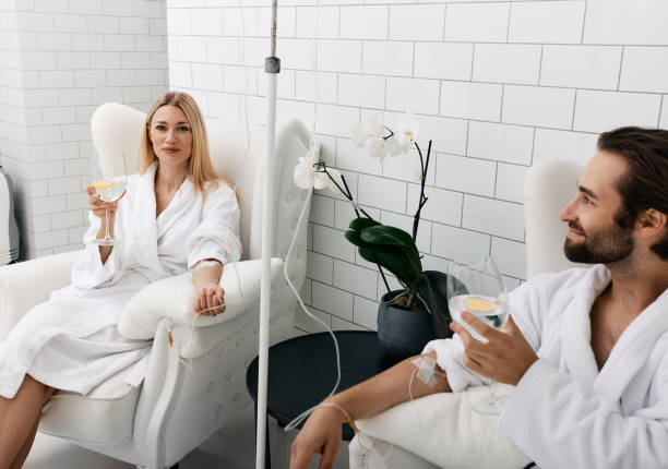 A man and woman relax, enjoying a spa treatment.