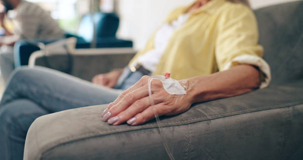 A woman receives an IV drip in her hand.